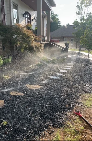Active Oxford MS irrigation system spraying across a residential landscape, the kind of system Oxford Lawn Pro winterizes each fall to prevent freeze damage
